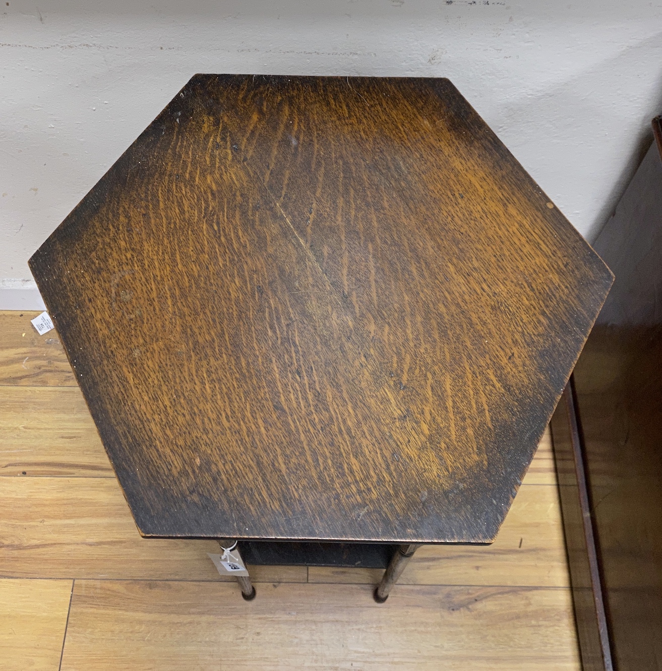 An early 20th century Liberty style hexagonal oak two tier occasional table, width 51cm, height 70cm
